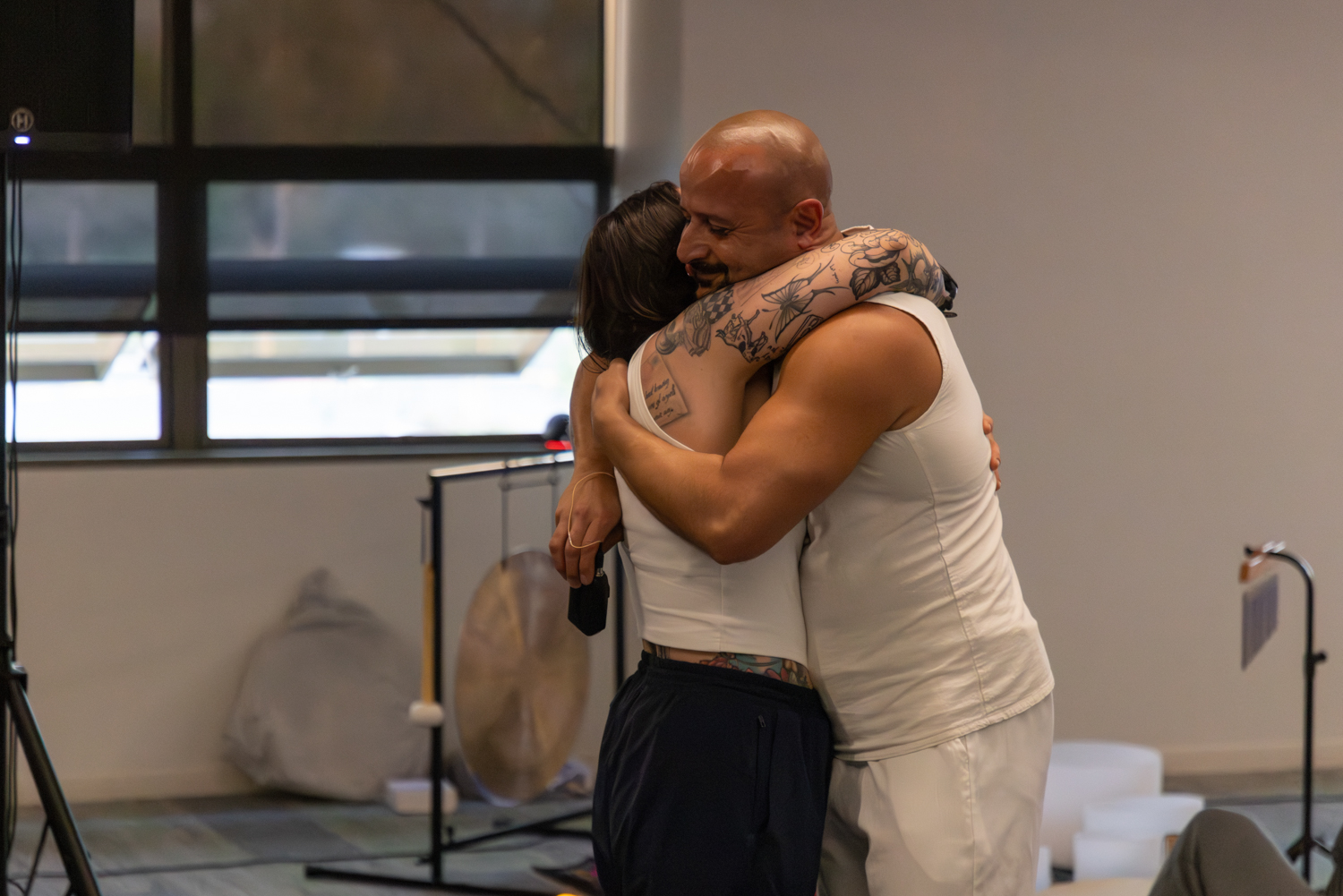 Two participants embracing after a ceremony