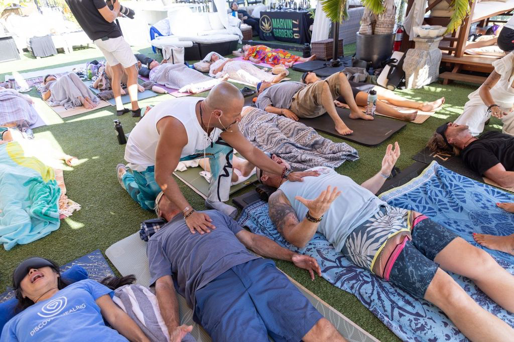 Group breathwork journey outdoors at an ƎVOLVE gathering