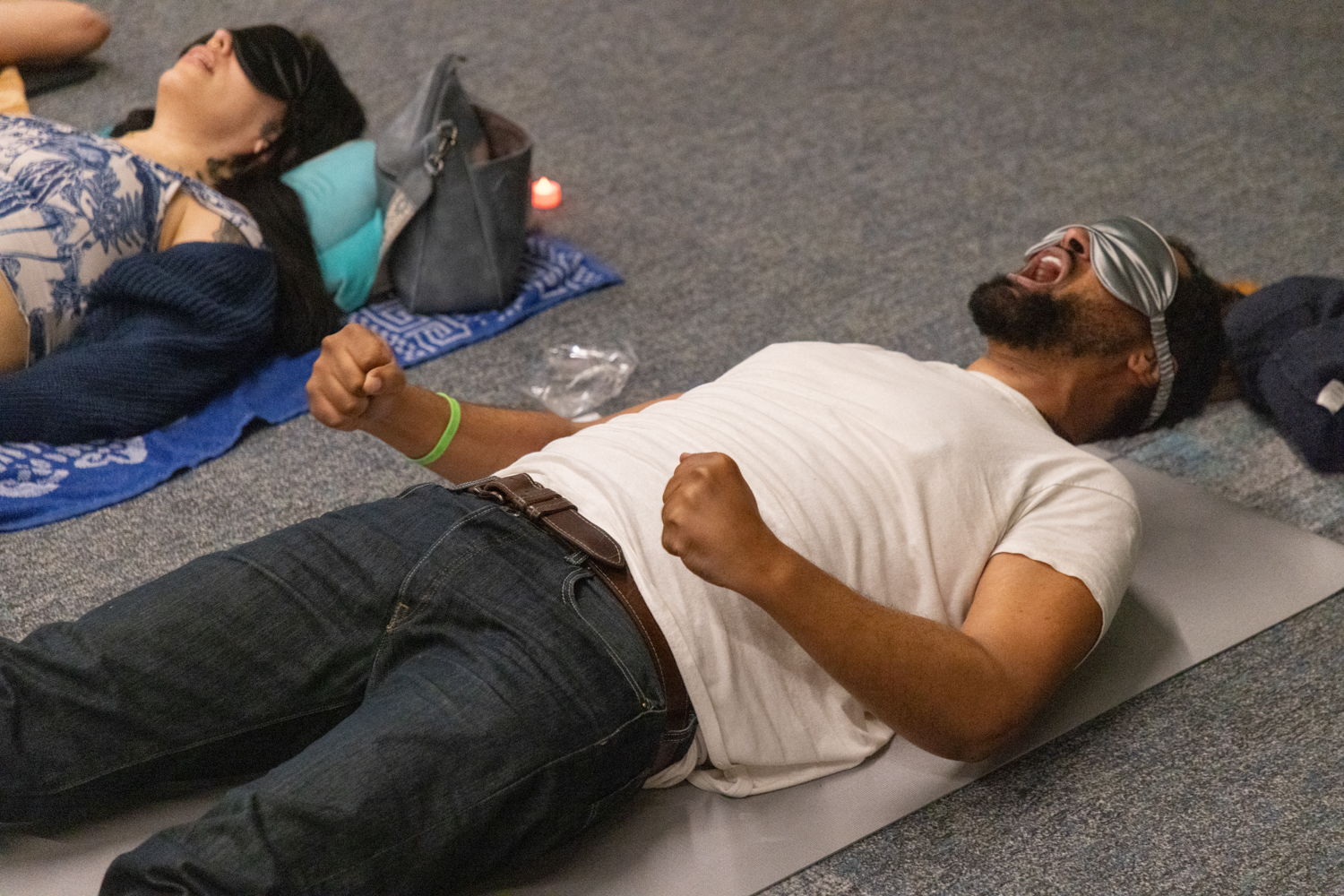 Participants lying blindfolded on mats during a breathwork release